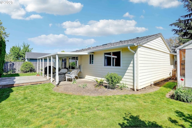 5219 Lacey Ct N, Keizer, OR 97303 - rear view of house with fence, a lawn, and a wooden deck