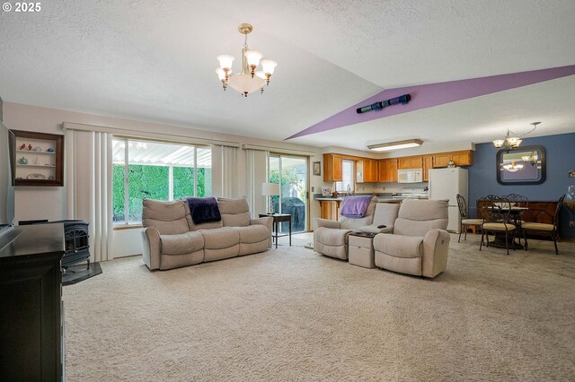 5219 Lacey Ct N, Keizer, OR 97303 - living room featuring light carpet, a notable chandelier, vaulted ceiling, and a textured ceiling
