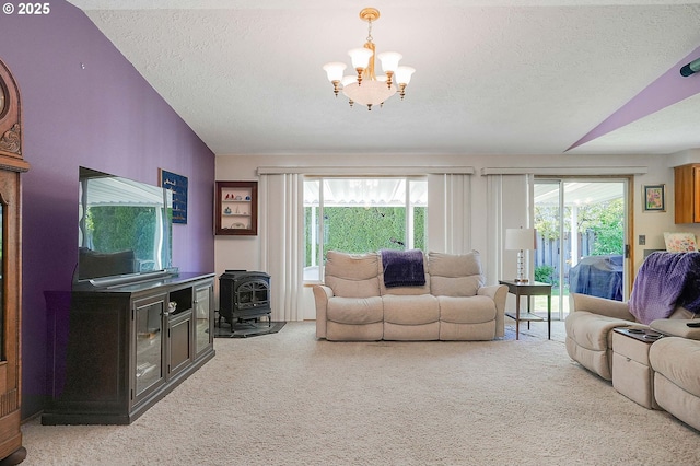 5219 Lacey Ct N, Keizer, OR 97303 - living area featuring a healthy amount of sunlight, a wood stove, a chandelier, and a textured ceiling