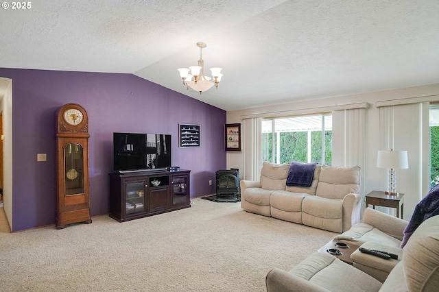 5219 Lacey Ct N, Keizer, OR 97303 - living room with carpet, lofted ceiling, a wood stove, a textured ceiling, and a notable chandelier