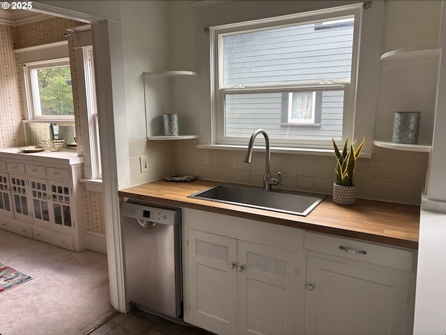 1824 NE 52nd Ave, Portland, OR 97213 - kitchen featuring stainless steel dishwasher, butcher block countertops, open shelves, decorative backsplash, and white cabinets