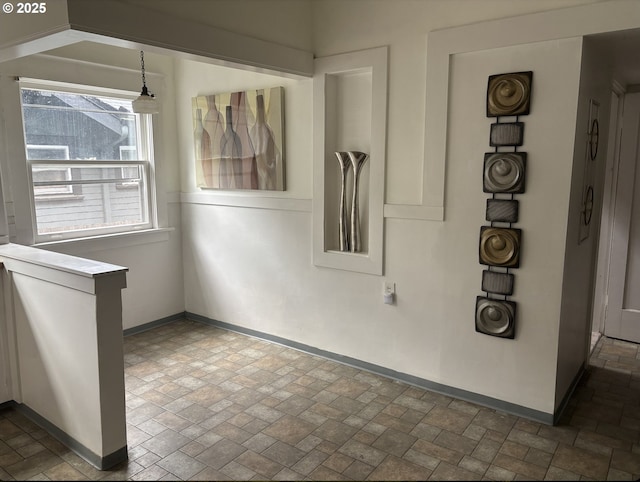 1824 NE 52nd Ave, Portland, OR 97213 - unfurnished dining area featuring baseboards and brick patterned flooring