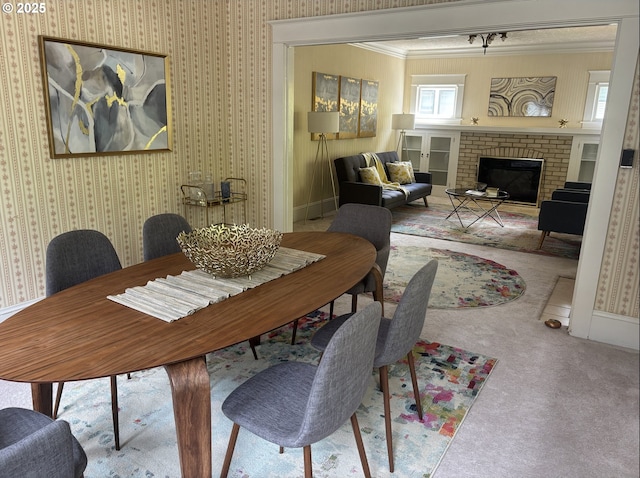 1824 NE 52nd Ave, Portland, OR 97213 - carpeted dining area with a brick fireplace, ornamental molding, and wallpapered walls