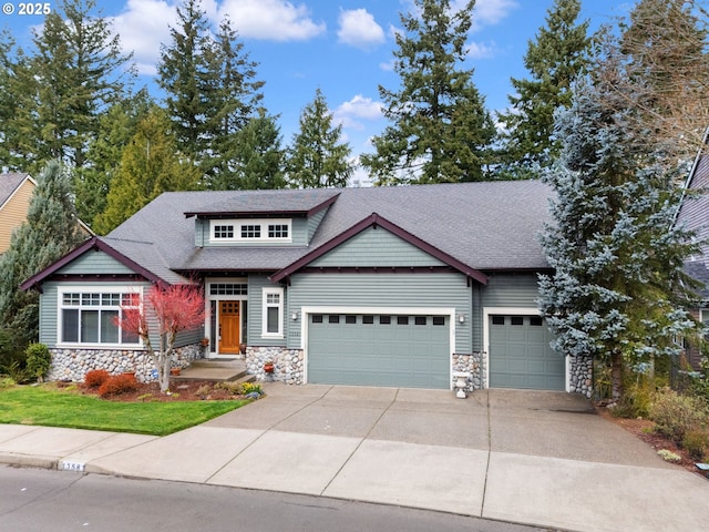 13581 SW Essex Dr, Portland, OR 97223 - craftsman house featuring stone siding, an attached garage, and a shingled roof