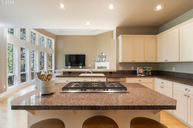 13581 SW Essex Dr, Portland, OR 97223 - kitchen with stainless steel appliances, a sink, a kitchen breakfast bar, recessed lighting, and open floor plan