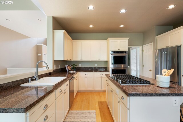 13581 SW Essex Dr, Portland, OR 97223 - kitchen with a sink, stainless steel appliances, light wood-style floors, recessed lighting, and a center island
