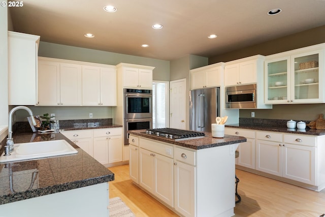 13581 SW Essex Dr, Portland, OR 97223 - kitchen with a sink, appliances with stainless steel finishes, light wood-style floors, white cabinetry, and recessed lighting