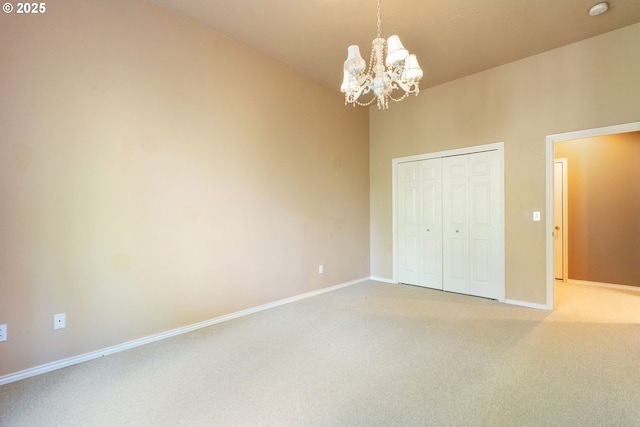 13581 SW Essex Dr, Portland, OR 97223 - unfurnished bedroom featuring a chandelier, light carpet, baseboards, and a closet