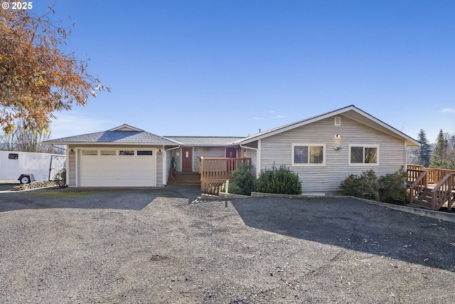 ranch-style home with a garage and a deck