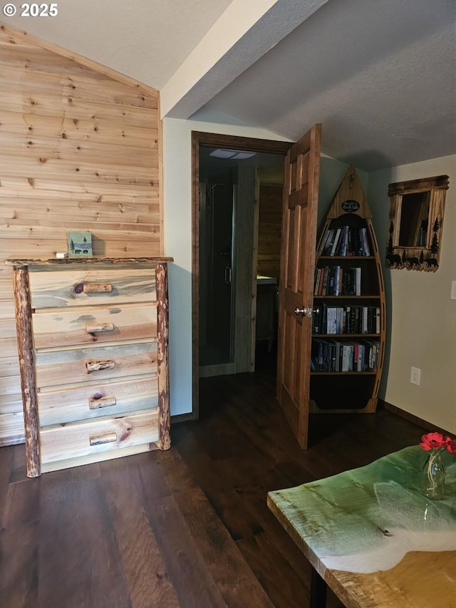 70202 Potato Bottom Rd, Lakeside, OR 97449 - corridor with vaulted ceiling, dark wood-style floors, baseboards, and wooden walls