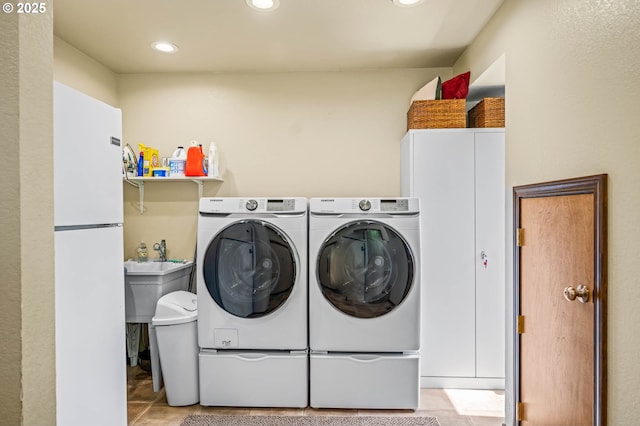 70202 Potato Bottom Rd, Lakeside, OR 97449 - laundry room with washing machine and dryer and recessed lighting