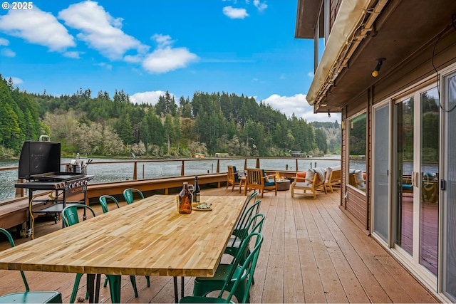70202 Potato Bottom Rd, Lakeside, OR 97449 - wooden terrace with a wooded view, a water view, outdoor lounge area, and outdoor dining space
