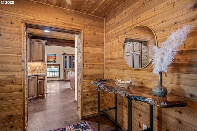 70202 Potato Bottom Rd, Lakeside, OR 97449 - hall featuring wooden walls, wood ceiling, and dark wood-style flooring