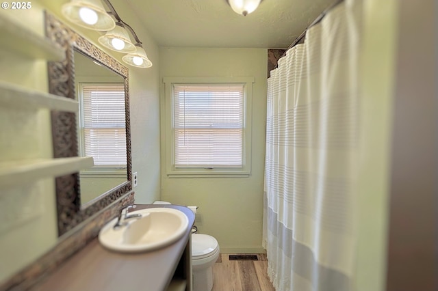 755 NE Ochoco Ave, Prineville, OR 97754 - full bath with vanity, toilet, a shower with shower curtain, wood finished floors, and visible vents