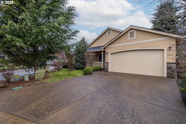 view of front of house with a garage, stone siding, and concrete driveway