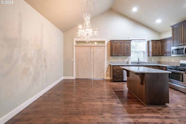 kitchen featuring dark wood-style flooring, appliances with stainless steel finishes, a sink, a kitchen island, and dark brown cabinets