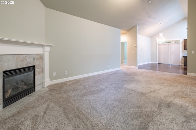 unfurnished living room with baseboards, a chandelier, carpet, a fireplace, and high vaulted ceiling