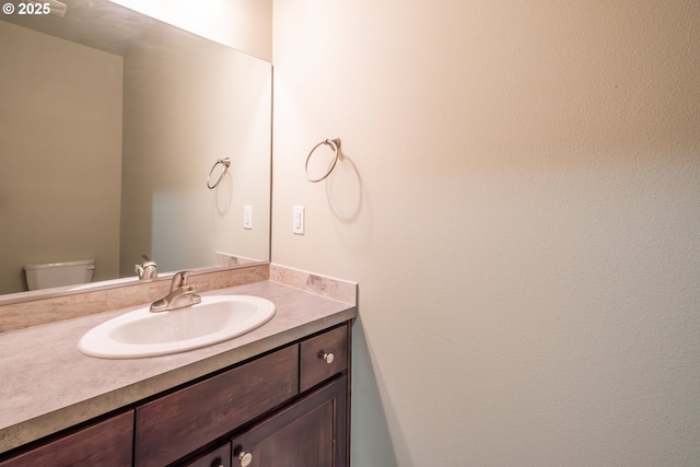 bathroom with toilet and vanity