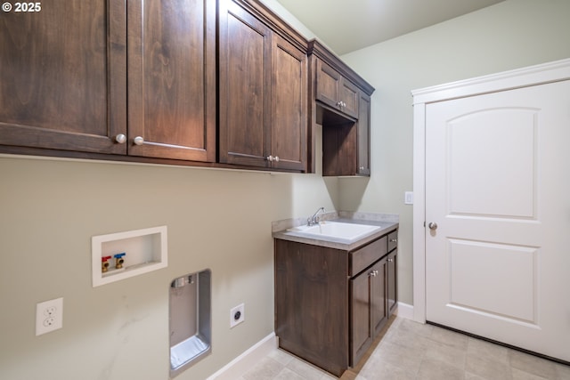 clothes washing area featuring washer hookup, cabinet space, a sink, electric dryer hookup, and baseboards