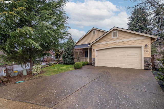 single story home featuring a garage, stone siding, and concrete driveway