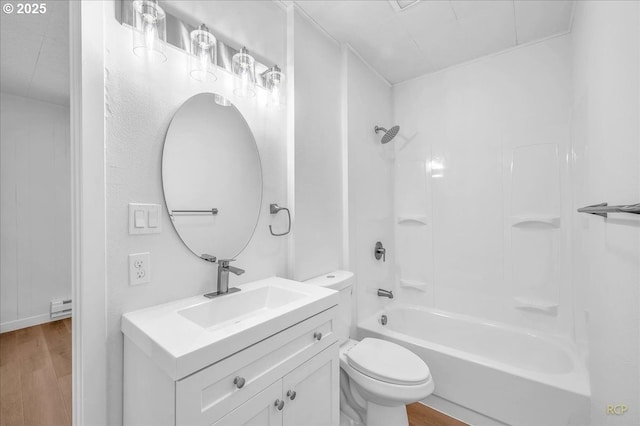 bathroom featuring vanity, wood finished floors, bathtub / shower combination, and toilet