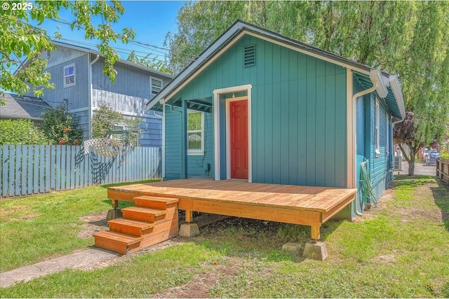 view of outbuilding featuring fence