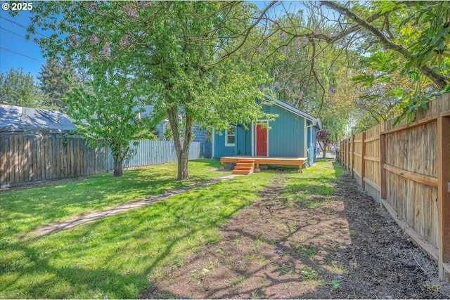 view of yard with a deck and a fenced backyard