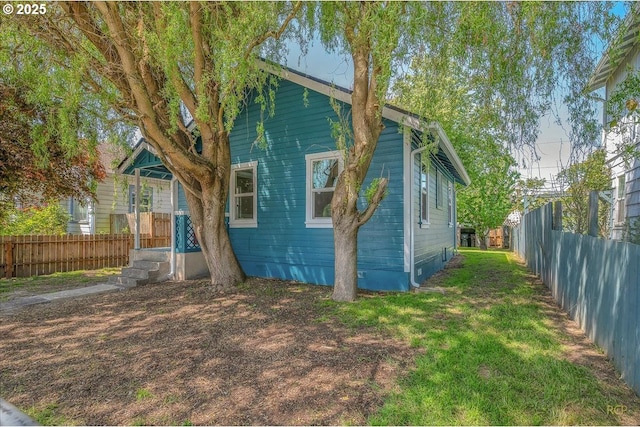exterior space featuring a fenced backyard and a yard