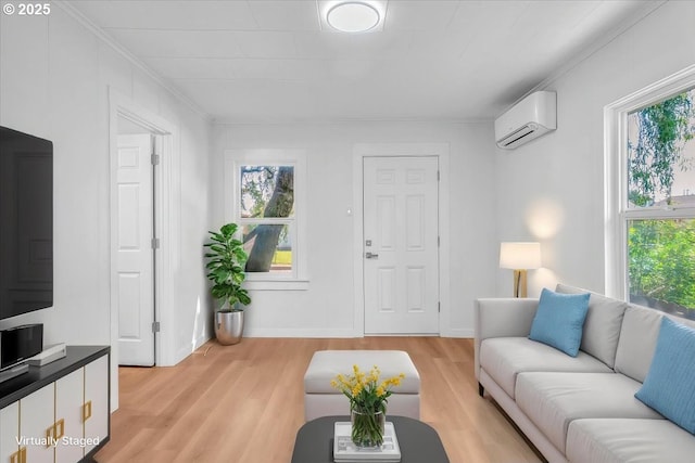 living room with crown molding, plenty of natural light, an AC wall unit, and light wood-type flooring