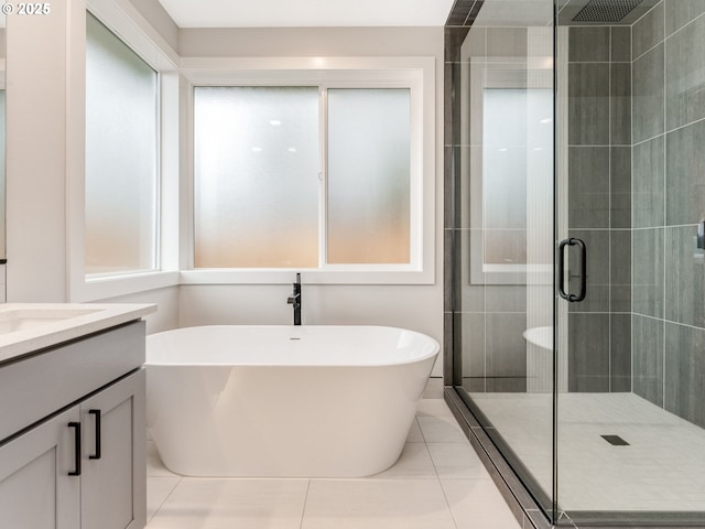 bathroom featuring tile patterned floors, vanity, and separate shower and tub