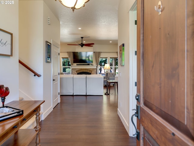 36280 SE Hauglum Rd, Boring, OR 97009 - entryway with a fireplace, ceiling fan, dark wood-type flooring, plenty of natural light, and a textured ceiling