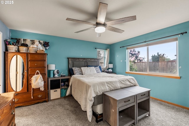 carpeted bedroom featuring a ceiling fan and baseboards