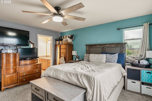 bedroom with light colored carpet, ceiling fan, and ensuite bathroom