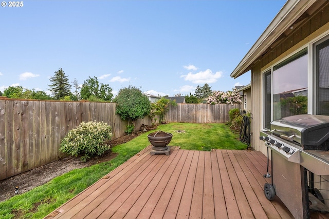 wooden deck featuring a fire pit