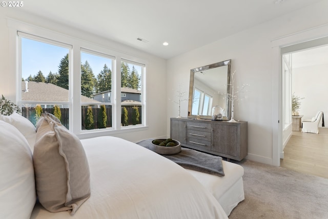 bedroom featuring light carpet