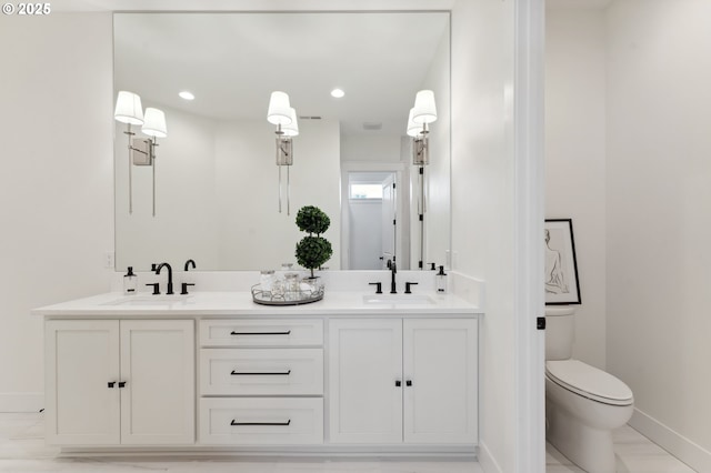 bathroom featuring vanity and toilet