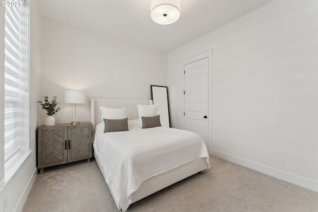 bedroom featuring light colored carpet