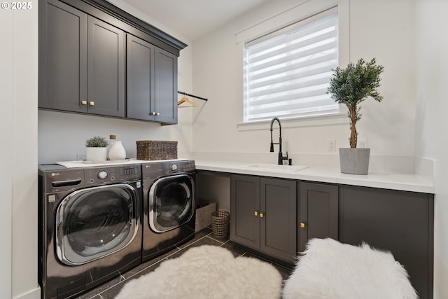 washroom featuring light tile patterned flooring, cabinets, sink, and washer and dryer