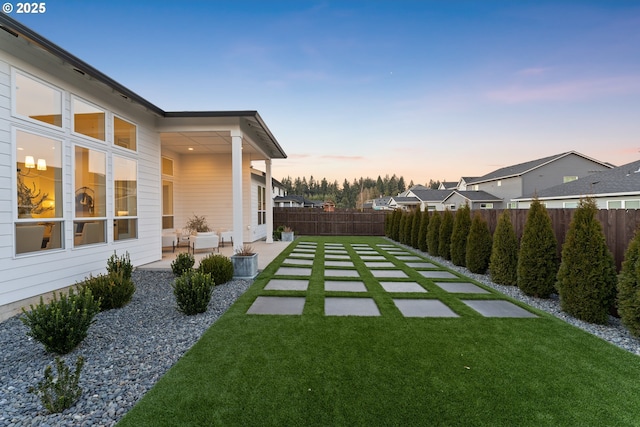 yard at dusk with a patio area