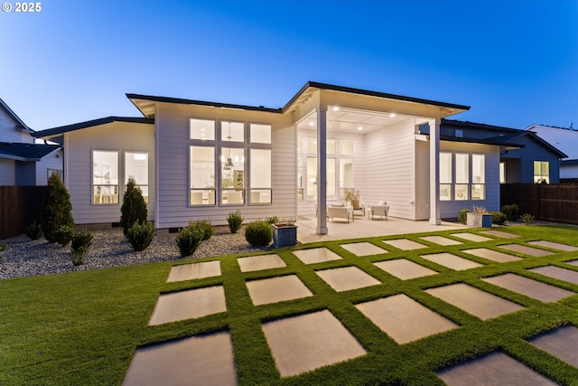 back of property featuring a yard and a patio area