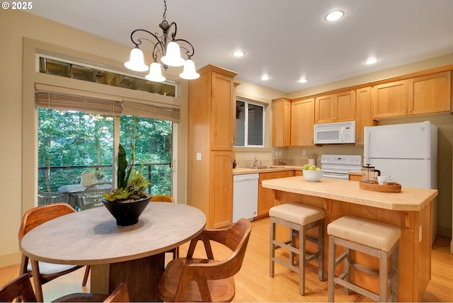 9400 SW 153rd Ave, Beaverton, OR 97007 - kitchen with white appliances, light wood finished floors, a kitchen island, a chandelier, and recessed lighting