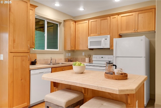 9400 SW 153rd Ave, Beaverton, OR 97007 - kitchen featuring white appliances, tile counters, light brown cabinetry, recessed lighting, and a kitchen bar