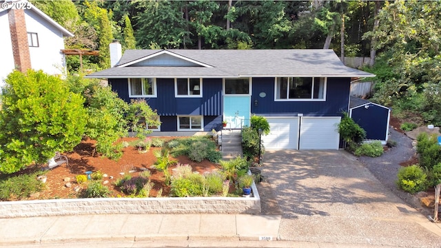 3580 Wilshire Ln, Eugene, OR 97405 - bi-level home with asphalt driveway, a garage, a shingled roof, and board and batten siding