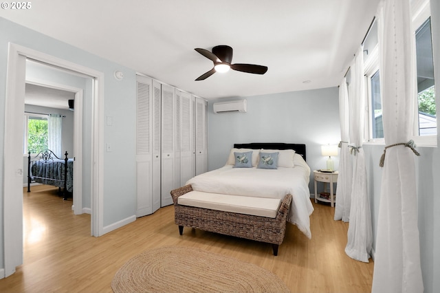 3580 Wilshire Ln, Eugene, OR 97405 - bedroom with a wall mounted air conditioner, light wood-style flooring, a ceiling fan, and a closet