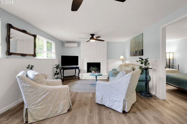 3580 Wilshire Ln, Eugene, OR 97405 - living room with a ceiling fan, a wall mounted AC, wood finished floors, a brick fireplace, and wainscoting