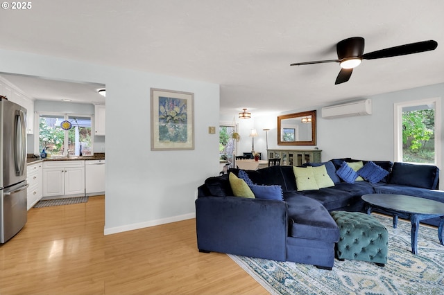 3580 Wilshire Ln, Eugene, OR 97405 - living room featuring an AC wall unit, light wood finished floors, and ceiling fan