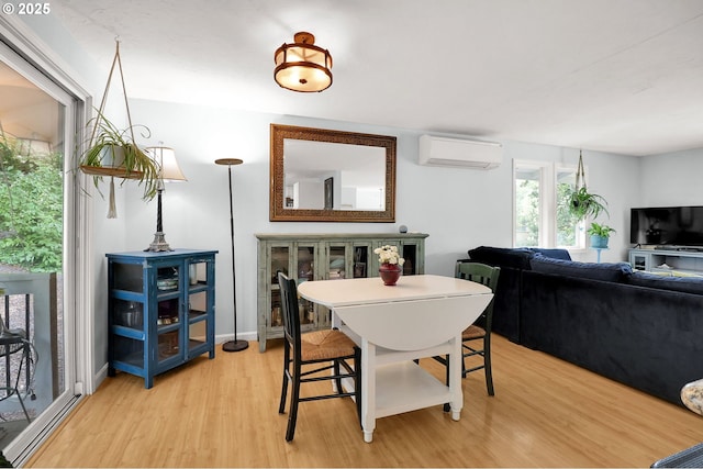 3580 Wilshire Ln, Eugene, OR 97405 - dining area with an AC wall unit and light wood-style flooring