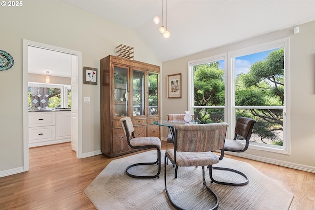 515 SW Colony Dr, Portland, OR 97219 - dining room with healthy amount of natural light, light wood finished floors, vaulted ceiling, and baseboards