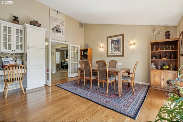 515 SW Colony Dr, Portland, OR 97219 - dining space featuring lofted ceiling, light wood-style floors, french doors, and baseboards