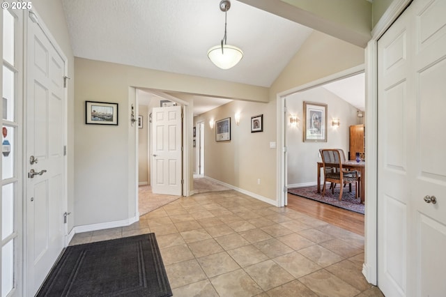 515 SW Colony Dr, Portland, OR 97219 - entryway with lofted ceiling, light tile patterned floors, and baseboards